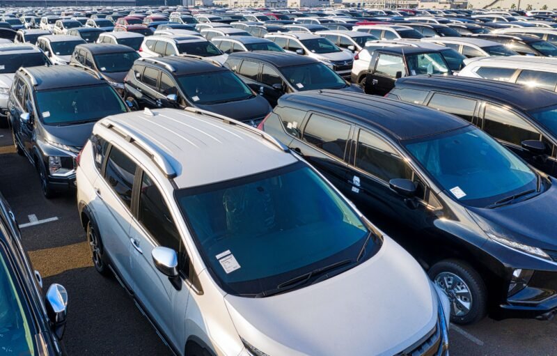 pexels-photo-5992514-5992514 Modern sparkling clean new automobiles on asphalt parking near factory of manufacture in daytime